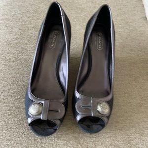 Coach black shoes with silver trim in a size 8.